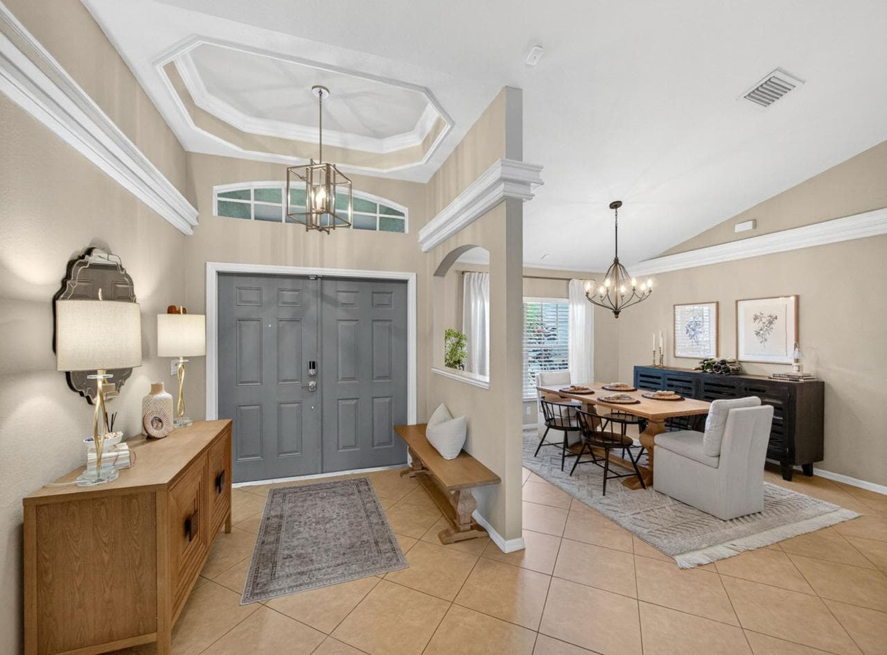 Grand foyer with vaulted ceiling and chandelier
